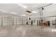 Spacious four car garage with high ceilings, storage racks, and multiple access doors at 2600 Robie Ave, Mount Dora, FL 32757