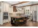 Well-appointed kitchen with stainless steel appliances, a large center island, and custom cabinetry at 2600 Robie Ave, Mount Dora, FL 32757