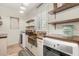 Bright laundry room features modern washer and dryer units, shiplap walls, and open shelving at 2600 Robie Ave, Mount Dora, FL 32757