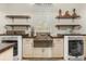 Well-appointed laundry room with a large sink, custom cabinets, and modern appliances at 2600 Robie Ave, Mount Dora, FL 32757