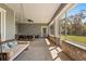 Spacious screened porch with a swing, outdoor furniture, and a view of the backyard at 2600 Robie Ave, Mount Dora, FL 32757