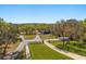 Large property featuring long driveway, two outbuildings, and lush mature landscaping at 2600 Robie Ave, Mount Dora, FL 32757