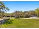 Large property featuring long driveway, two outbuildings, and lush mature landscaping at 2600 Robie Ave, Mount Dora, FL 32757