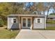 A well-maintained shed with white trim and a covered entrance, offering storage and functionality at 2600 Robie Ave, Mount Dora, FL 32757
