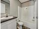 Well-lit bathroom featuring a shower-tub combo and sleek vanity with dark countertop at 0 Allison Ave, Lake Wales, FL 33859