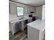 Modern kitchen with gray cabinets, stainless steel appliances, and a marble countertop island at 0 Allison Ave, Lake Wales, FL 33859