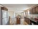 Open kitchen and living area featuring stainless steel appliances and modern wood flooring at 0 Allison Ave, Lake Wales, FL 33859