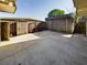 Backyard featuring a concrete patio, wood fencing, and minimal plants at 1009 Royal Oak Blvd, Leesburg, FL 34748