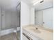 Bathroom with a bathtub, shower, toilet, and extended vanity with a large mirror at 1009 Royal Oak Blvd, Leesburg, FL 34748