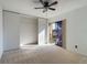 Bedroom showing the closet, fan, and sliding glass door to the balcony at 1009 Royal Oak Blvd, Leesburg, FL 34748