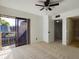 Bedroom featuring a sliding glass door, neutral carpeting, and ceiling fan at 1009 Royal Oak Blvd, Leesburg, FL 34748