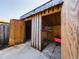 A weathered, wooden shed with two compartments sits on a concrete foundation, ideal for storage or a workshop at 1009 Royal Oak Blvd, Leesburg, FL 34748