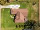 Aerial view of a beautiful home, green lawn, and backyard pool at 10846 Point Nellie Dr, Clermont, FL 34711