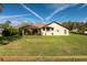 Beautiful backyard with a screened in porch, lush lawn, and a nice view at 10846 Point Nellie Dr, Clermont, FL 34711