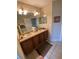 Bathroom with double sink vanity and neutral tile flooring at 10846 Point Nellie Dr, Clermont, FL 34711