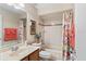 Cozy bathroom with shower and tub combination with neutral tile and bright lighting at 10846 Point Nellie Dr, Clermont, FL 34711