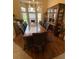 Traditional dining room featuring hardwood floors, natural light, a chandelier, and a large wooden table at 10846 Point Nellie Dr, Clermont, FL 34711