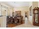 Elegant dining room with traditional furniture, a large chandelier, and natural light at 10846 Point Nellie Dr, Clermont, FL 34711