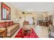 Bright living room with tile floors, large window, and front door at 10846 Point Nellie Dr, Clermont, FL 34711