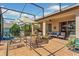 Outdoor patio is screened-in with a seating area, a ceiling fan, and tiled floors at 10846 Point Nellie Dr, Clermont, FL 34711