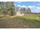 Backyard features a small storage shed and a wooden fence surrounded by trees at 109 Pecan Pass, Ocala, FL 34472