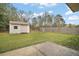 Backyard features a small storage shed, a wooden fence, and a concrete patio at 109 Pecan Pass, Ocala, FL 34472