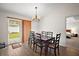 Elegant dining room featuring a chandelier, hardwood floors, and a sliding glass door at 109 Pecan Pass, Ocala, FL 34472