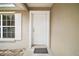 Close-up of the inviting front door with white trim and a welcoming mat at 109 Pecan Pass, Ocala, FL 34472