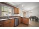 Well-lit kitchen with granite countertops, stainless steel appliances, and an adjacent dining area at 109 Pecan Pass, Ocala, FL 34472