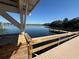 View of a lake with a dock extending over the lake at 1127 Belmont Cir, Tavares, FL 32778