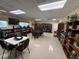 Large well-lit library with bookshelves and tables at 1127 Belmont Cir, Tavares, FL 32778