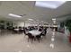 Spacious meeting room with tables and chairs, a white floor, and a well lit ceiling at 1127 Belmont Cir, Tavares, FL 32778