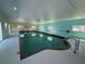 Indoor pool with natural light, grab bar, and brick lining at 1127 Belmont Cir, Tavares, FL 32778