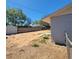 Exterior view of the backyard showing the layout, partial grass, and a wooden fence at 115 N Galena Ave, Minneola, FL 34715