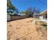 Exterior view of the backyard showing the layout, partial grass, and a wooden fence at 115 N Galena Ave, Minneola, FL 34715