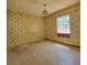 Unique bedroom showcasing patterned wallpaper and natural light from a single window at 115 N Galena Ave, Minneola, FL 34715