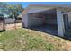 Exterior view of a covered carport with painted cement block walls and partial grass area at 115 N Galena Ave, Minneola, FL 34715