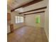 Bright dining room features tile flooring, beamed ceilings, and natural light from a large window at 115 N Galena Ave, Minneola, FL 34715