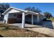 Exterior shot of home with an open, airy carport area at 115 N Galena Ave, Minneola, FL 34715