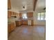 Bright kitchen with tile flooring, classic cabinets, and space for personalization at 115 N Galena Ave, Minneola, FL 34715