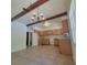 Open kitchen area with a retro chandelier and tile flooring, ready for a modern upgrade at 115 N Galena Ave, Minneola, FL 34715