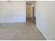 Spacious living room space with tile flooring and access to other rooms at 115 N Galena Ave, Minneola, FL 34715