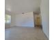 Bright living room area featuring a large window and access to other rooms at 115 N Galena Ave, Minneola, FL 34715