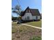 Side view of a Tudor-style home featuring an expansive grassy backyard at 1326 East Ave, Clermont, FL 34711