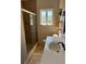 Bathroom featuring tiled walls, a glass shower door, and a toilet at 1326 East Ave, Clermont, FL 34711