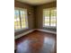 Bedroom featuring hardwood floors and two large windows for ample light at 1326 East Ave, Clermont, FL 34711