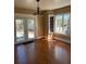 Bright living room featuring hardwood floors, a chandelier, and a glass door leading outside at 1326 East Ave, Clermont, FL 34711