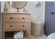 Modern bathroom with a white vanity, marble wall, and basket for storage at 1391 E Crooked Lake Dr, Eustis, FL 32726