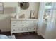 Bright bedroom features a white dresser with seven drawers and natural light at 1391 E Crooked Lake Dr, Eustis, FL 32726