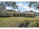 Charming single-story home featuring a covered front porch and a well-manicured lawn at 1391 E Crooked Lake Dr, Eustis, FL 32726